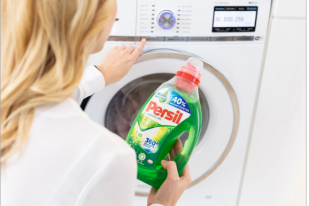 A woman holding the product Persil in her hands.