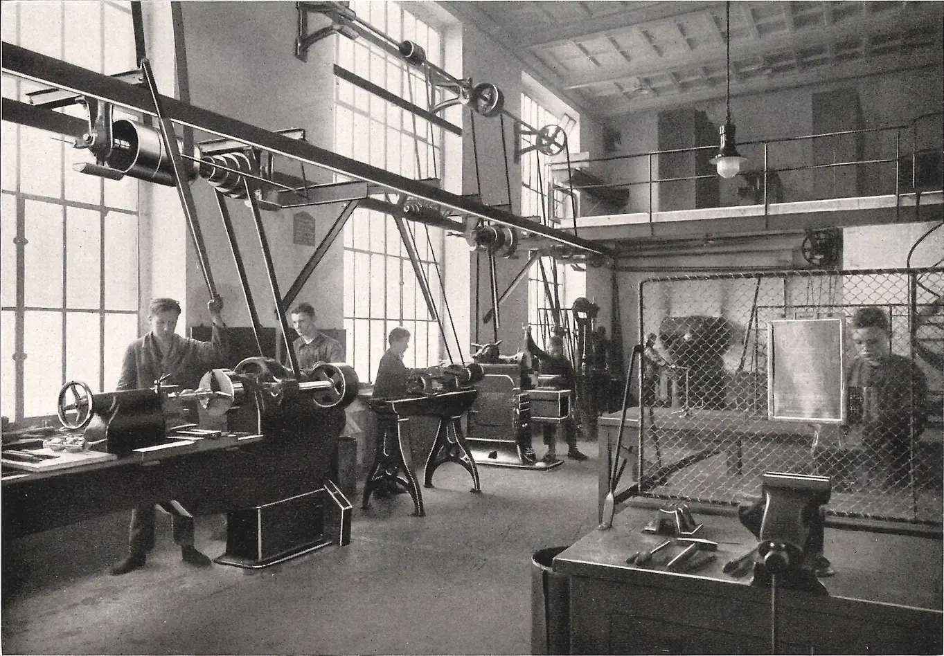 Apprentices working on machines in the metalworking workshop.
